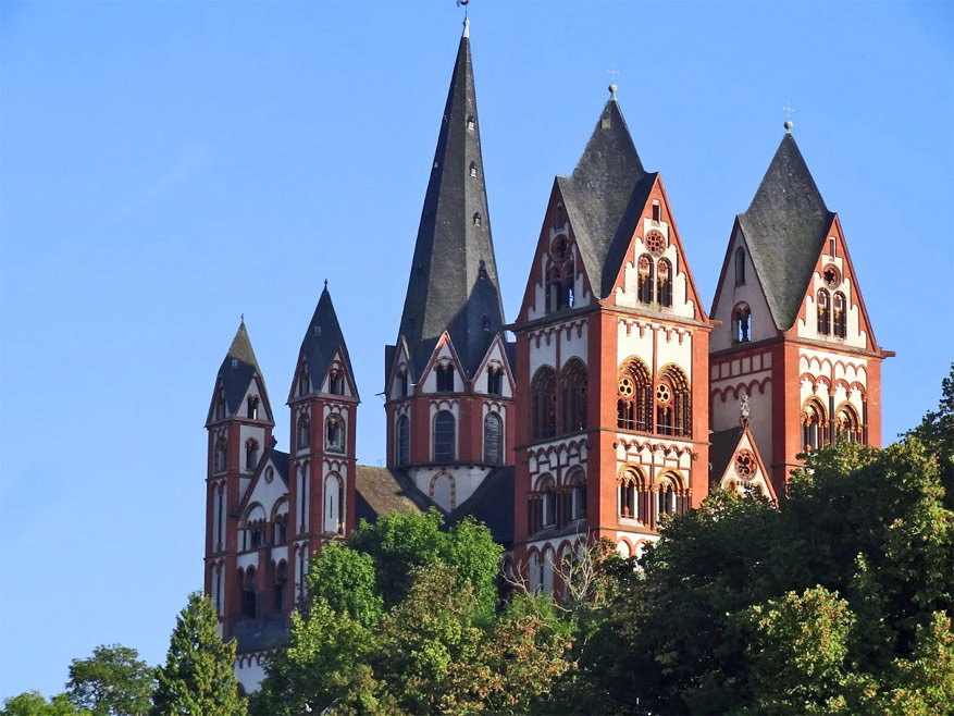 De zeven torens van de Limburgse dom torenen hoog boven de stad uit.
