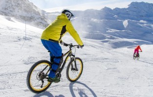 Fat bike: kan je ’s winters het fietsen niet loslaten? Dan is fat biking iets voor jou! Op een mountainbike met stevige, dikke banden trotseer je namelijk de bergen op een veilige, maar spannende manier. Een nadeel: je hebt er wel een goede conditie voor nodig. Gezegd wordt dat fat biking zelfs meer energie vraagt dan het klassieke mountainbiken. Maar in bepaalde skigebieden spelen ze daar goed op in door fat bikes met een powerbatterij aan te bieden. © Val Thorens / C. Cattin